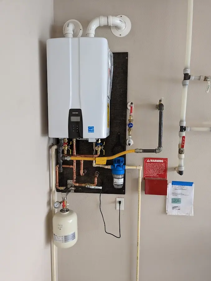 Professional plumber installing copper piping in a Pine Hill home